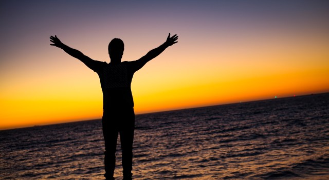 man arms outstretched red sky shah-rokh-AMwEpSGALSU-unsplash